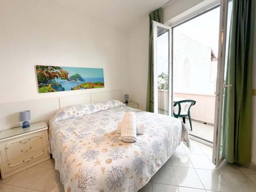 a bedroom with a bed and a large window at Av Club Terme Colella in Ischia