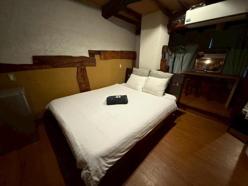a bedroom with a white bed with a purse on it at Tokyo House INN in Tokyo
