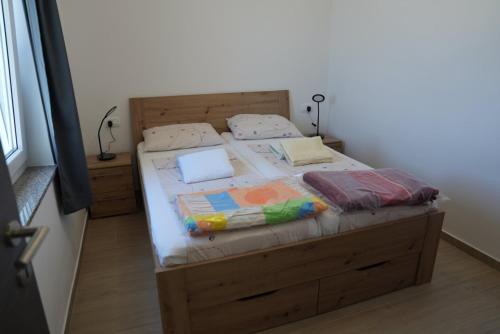 a bedroom with a wooden bed with a wooden headboard at Villa Ivanovic in Vir
