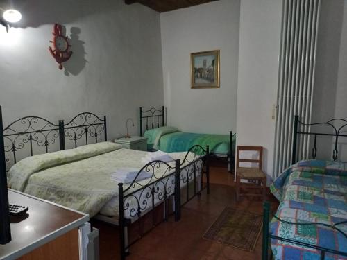 a bedroom with two beds and a table and chairs at Affittacamere La Contadina Sisina in Aliano