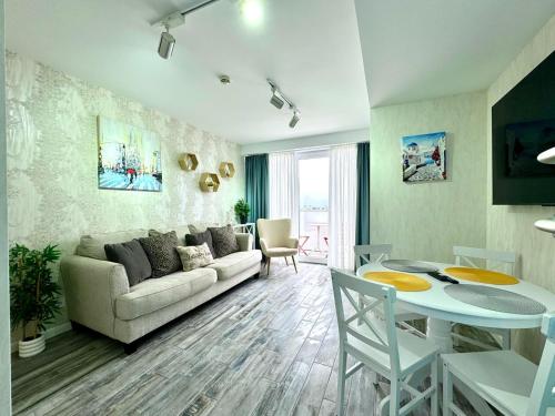 a living room with a couch and a table at My Sunshine Apartments in Batumi in Batumi