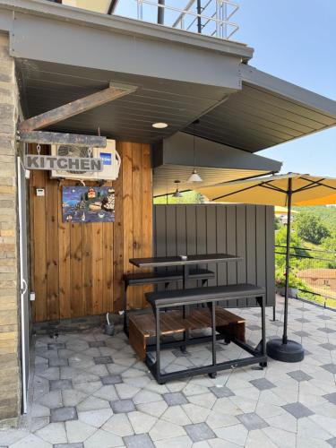 a patio with two tables and an umbrella at Velestovo Panorama House in Velestovo