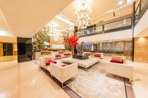 a living room with couches and a lobby at Grand Jatra Hotel Balikpapan in Balikpapan