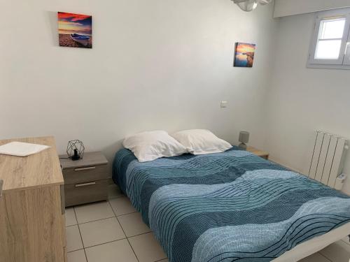 une chambre avec un lit et un bureau et un lit sidx sidx sidx dans l'établissement Maison familiale avec piscine, à Barbâtre