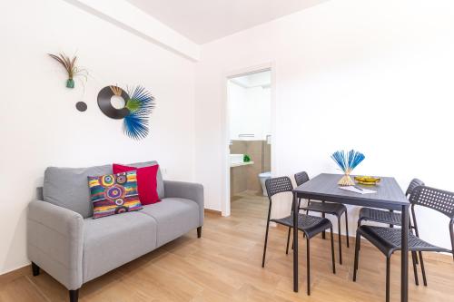 a living room with a couch and a table at Granatelli Holiday Home in Altavilla Milicia