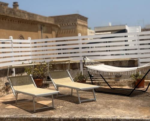 two chairs and a hammock on a rooftop at Kasa Celeste Aida in Gallipoli