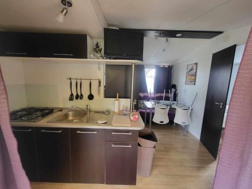 une petite cuisine avec un évier et une cuisinière dans l'établissement Vidil home, à Saint-Remèze
