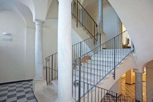a spiral staircase in a building with columns at Albergo Palazzo Costa in Beverino