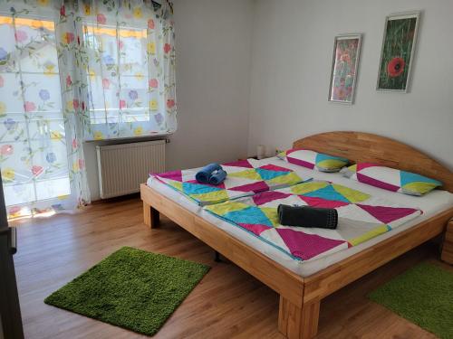 a bedroom with a bed with a colorful quilt on it at Bodensee Idylle in Friedrichshafen