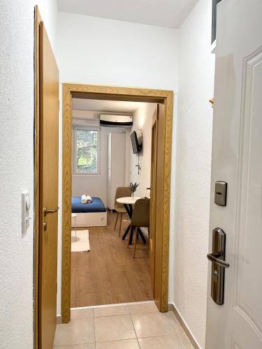 a door leading into a room with a bedroom at Modern Central Studio - 3 min walk to lake in Ohrid