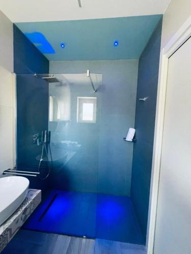 a bathroom with a glass shower with a toilet at Aquamarì Charme Rooms in Vieste