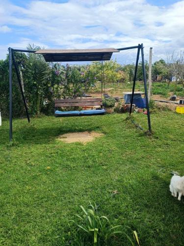 a park with a bench in the grass at Dar Nawara 3bedroom Villa with pool and amazing garden in Tazarka