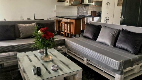 a living room with two couches and a coffee table at Dar Nawara 3bedroom Villa with pool and amazing garden in Tazarka