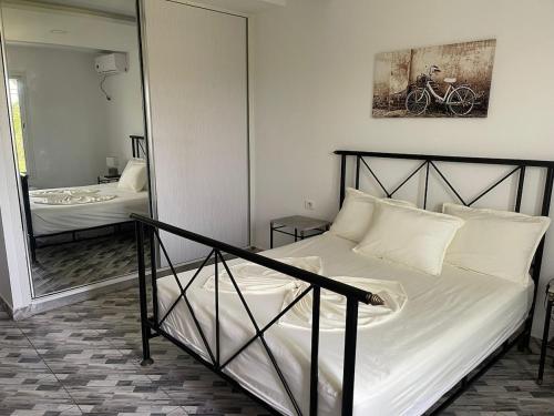 a bed in a room with a mirror and a bed sidx sidx sidx at Dar Nawara 3bedroom Villa with pool and amazing garden in Tazarka