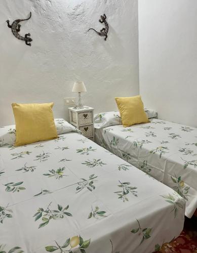 two beds sitting next to each other in a room at Can Mateu 1924 in Sant Francesc Xavier