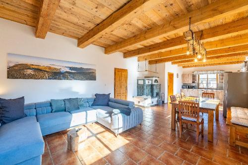 a living room with a blue couch and a table at Chalupy Jesenická dvojčata in Šumperk