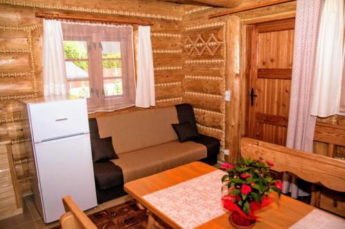 a living room with a couch and a table at Domki na Skalistej w Szczyrku in Szczyrk