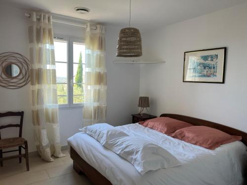 une chambre avec un lit et une fenêtre dans l'établissement Villa LAGON et GARRIGUE, à Saint-Maximin