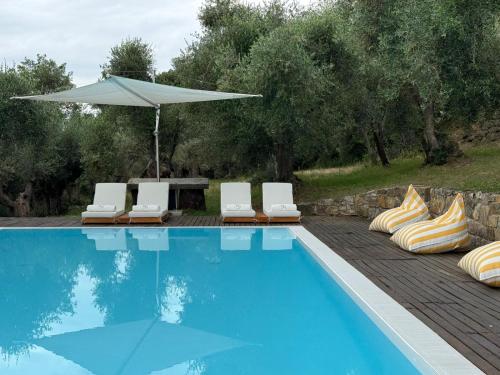 a swimming pool with lounge chairs and an umbrella at Villa Gamberaia in Settignano