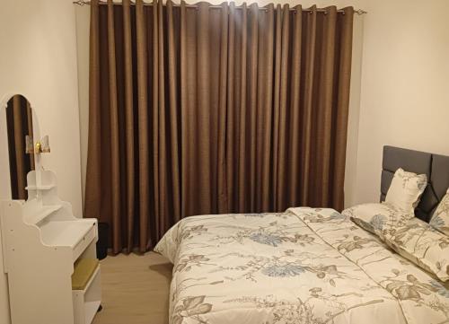 a bedroom with a bed and brown curtains at Cozy Beautiful Private Room with Shared Washroom in Ajman 