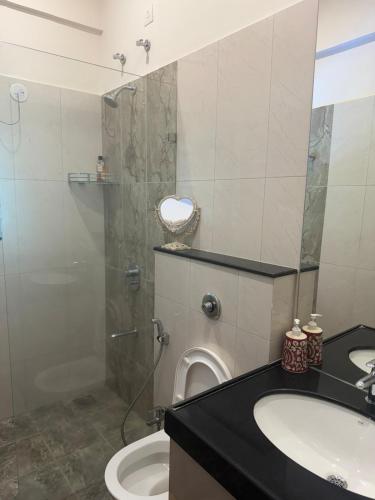 a bathroom with a shower and a toilet and a sink at 3 Bed apartment in North Goa in Old Goa