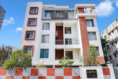 a tall white building with a sign on it at Super Aarambh Exotica in Pune