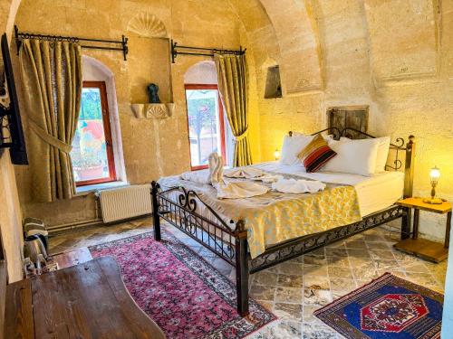 Ένα ή περισσότερα κρεβάτια σε δωμάτιο στο Nomads Cave Hotel & Rooftop