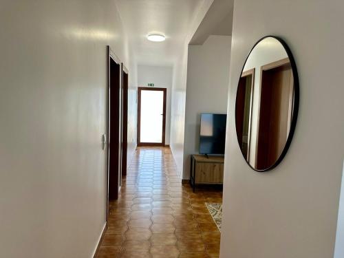 a hallway with a mirror on a wall at Anita & Leonel's House B in Gaula