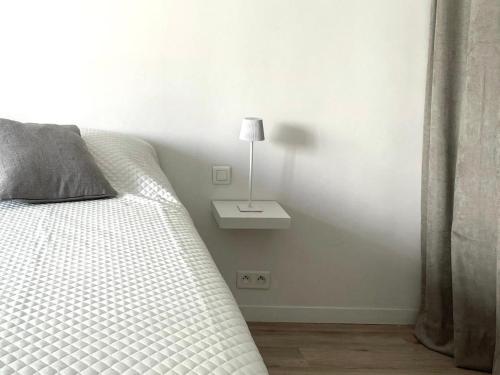 - une chambre avec un lit et une lampe sur une table de chevet dans l'établissement Studio chic, Cannes Croisette 10 min, au Cannet