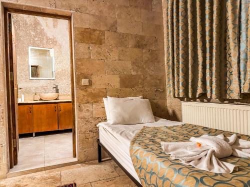Ένα ή περισσότερα κρεβάτια σε δωμάτιο στο Nomads Cave Hotel & Rooftop