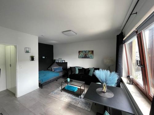 a living room with a couch and a table at Apartment Nr 15 in Bremerhaven