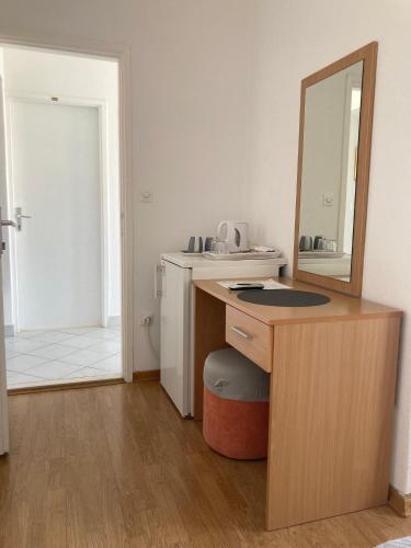 a bathroom with a vanity with a mirror and a sink at Apartments Slijepcevic in Hvar