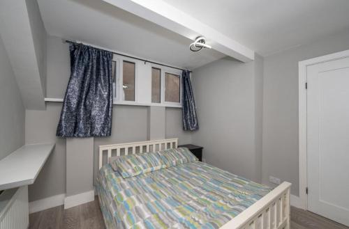 a small bedroom with a bed and a window at Charming City Retreat in Cork in Cork