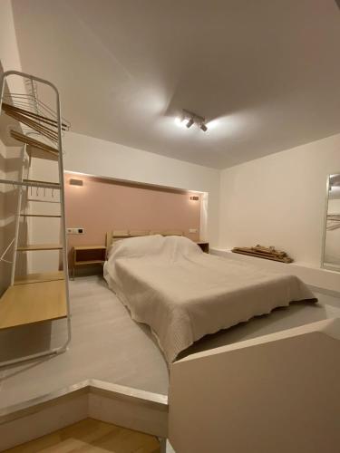 a bedroom with a bed and a ladder at Cosy Nest In Samos in Samos