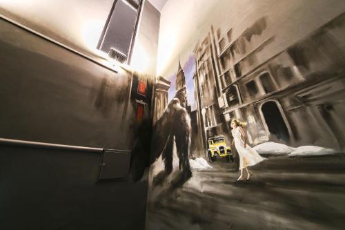 a painting of a man and woman walking down a street at Yeongdeungpo Station New York Hotel in Seoul