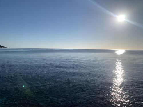 a view of the ocean with the sun reflecting on the water at SOLUS B&B in Casteldaccia