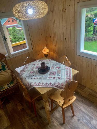 a wooden table in a room with a table and chairs at Chata Mandl - Klid, příroda, soukromí in Řetová