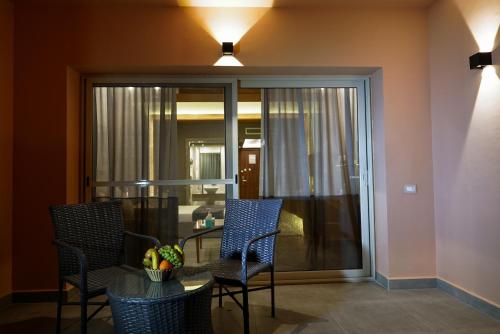 a room with a table and chairs and a glass door at Ali Baba Palace Resort in Hurghada
