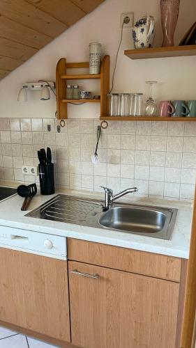 a kitchen with a sink and a counter at Villa am Goldbach in Bad Aibling