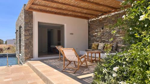 a patio of a house with a table and chairs at Egeo Paros in Kampos Paros