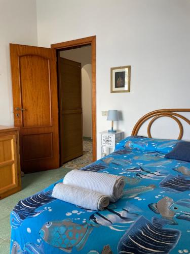 a bed with a towel sitting on top of it at Casatalento2 in Ponza