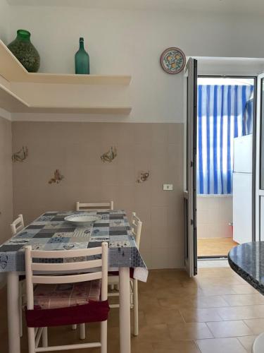a dining room with a table and chairs and a window at Casatalento2 in Ponza