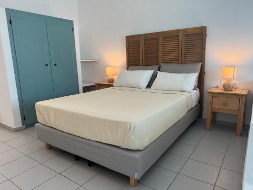 a bedroom with a large bed and two night stands at Esperos Apartments&Studios in Troulos