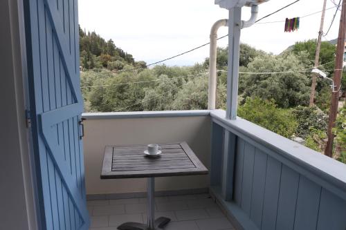 a small table on a balcony with a view at Villa Milia 2 in Agios Nikitas