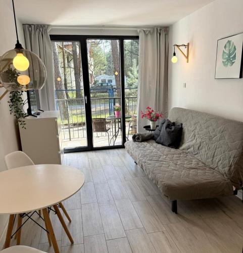 a living room with a couch and a table at Perła in Stegna