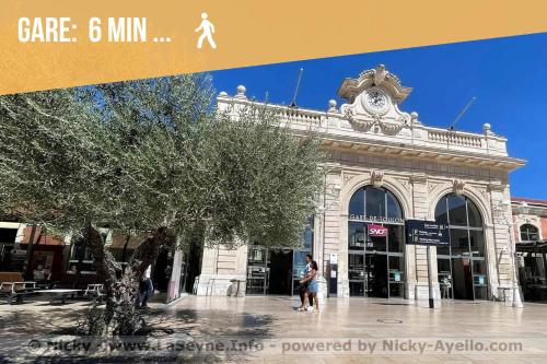un bâtiment avec une horloge en haut dans l'établissement Le Liberté - Charme & Standing haussmannien avec vue port, à Toulon