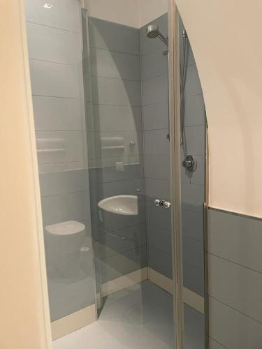 a bathroom with a glass shower with a sink at Via Roma 10 in Trapani