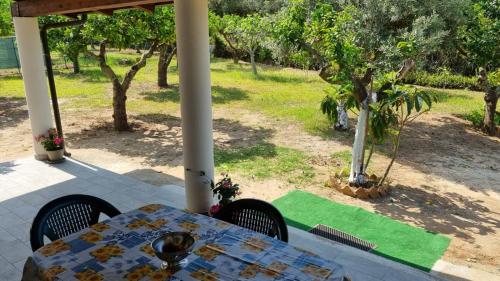 a table and chairs sitting on a patio at Orange Villa in Capo Vaticano