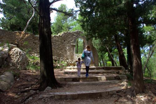 a woman and a child walking up some stairs at Apartments Lux in Makarska