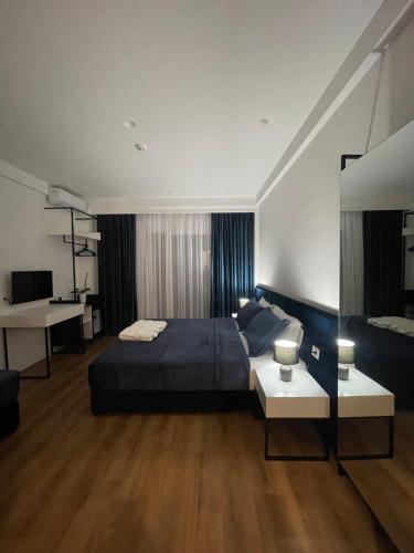 a bedroom with a large bed and a desk at SEA & LAKE VIEW VILLA in (( Kalive Gjoka ))
